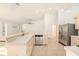 Kitchen with stainless steel appliances, tiled floors, and a breakfast bar that opens to the living area at 1559 Overland Dr, Spring Hill, FL 34608