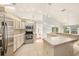 View of the kitchen with modern stainless steel appliances and a breakfast bar overlooking the living space at 1559 Overland Dr, Spring Hill, FL 34608