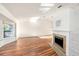 Bright living room features hardwood floors, vaulted ceilings, and a cozy fireplace at 1559 Overland Dr, Spring Hill, FL 34608