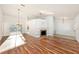 Expansive living room featuring hardwood floors, a fireplace, and access to the pool area at 1559 Overland Dr, Spring Hill, FL 34608