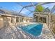 Lovely pool inside a screened enclosure with a nice deck, ladder, and views to the home at 1559 Overland Dr, Spring Hill, FL 34608