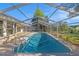 Screened-in pool with clear water, concrete patio, and ladder access. Perfect for relaxation at 1559 Overland Dr, Spring Hill, FL 34608