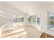Sunroom with tile flooring, large sliding glass doors leading to the pool area, and natural light at 1559 Overland Dr, Spring Hill, FL 34608