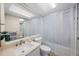 Bright bathroom featuring a large mirror and a shower-tub combo at 17920 Gulf Blvd # 1103, Redington Shores, FL 33708