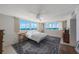 Bright bedroom with large windows offering panoramic ocean views and a ceiling fan at 17920 Gulf Blvd # 1103, Redington Shores, FL 33708