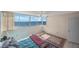 Bright bedroom featuring an ocean view, tile floor, ceiling fan, and neutral decor at 17920 Gulf Blvd # 1103, Redington Shores, FL 33708