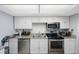 Kitchen featuring stainless steel appliances, granite countertops and bright cabinetry at 17920 Gulf Blvd # 1103, Redington Shores, FL 33708