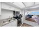 Bright kitchen with stainless steel appliances has views through living room to balcony and the ocean at 17920 Gulf Blvd # 1103, Redington Shores, FL 33708