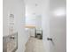 Hallway shot of a laundry room complete with a washer, dryer, sink, and storage at 17920 Gulf Blvd # 1103, Redington Shores, FL 33708