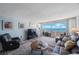 Bright living room with sliders open to balcony with water views and comfortable seating at 17920 Gulf Blvd # 1103, Redington Shores, FL 33708