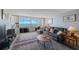 Cozy living room featuring sliders to balcony with stunning ocean views and comfortable seating at 17920 Gulf Blvd # 1103, Redington Shores, FL 33708