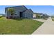 View of the home's exterior highlighting its well-kept lawn, landscaping, and neighborhood setting at 2375 Harris Hawk Ave, Ruskin, FL 33570