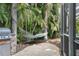 Backyard with hammock, grill, stone countertop, and mature trees offering a private and relaxing outdoor space at 2981 Northfield Dr, Tarpon Springs, FL 34688