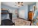Bedroom featuring a treadmill, ceiling fan, hardwood floors, a large rug, and a window with plantation shutters at 2981 Northfield Dr, Tarpon Springs, FL 34688