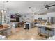 Open-concept kitchen with stainless steel appliances and granite countertops overlooking the living area at 2981 Northfield Dr, Tarpon Springs, FL 34688