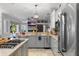 Well-equipped kitchen featuring stainless steel appliances and granite countertops, open to the living area at 2981 Northfield Dr, Tarpon Springs, FL 34688