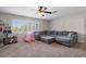 Bright living room with a gray sectional couch, a window with shutters and a playful tent at 2981 Northfield Dr, Tarpon Springs, FL 34688