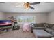 Spacious carpeted living room offers natural light and a comfortable seating area with a large sectional couch at 2981 Northfield Dr, Tarpon Springs, FL 34688