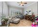 Bright sitting area with large windows, plantation shutters and decorative accents at 2981 Northfield Dr, Tarpon Springs, FL 34688