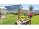 Expansive backyard featuring a playground, swing set, and ample green space for outdoor activities and enjoyment at 3224 Fresno Pl, Zephyrhills, FL 33541
