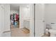 A bathroom with a walk-in closet, a single sink vanity, and a toilet at 3224 Fresno Pl, Zephyrhills, FL 33541