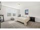 A bedroom with a carpeted floor, a bed, two windows, and a nightstand at 3224 Fresno Pl, Zephyrhills, FL 33541
