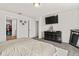 A bedroom with a bed, a large TV, and a dresser at 3224 Fresno Pl, Zephyrhills, FL 33541
