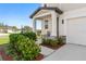 Cozy front porch with seating and well-manicured landscaping at 3224 Fresno Pl, Zephyrhills, FL 33541