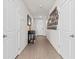 Inviting hallway with wood-look tile flooring and stylish decor at 3224 Fresno Pl, Zephyrhills, FL 33541