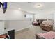 A living room with carpet, a brown leather couch, and a window at 3224 Fresno Pl, Zephyrhills, FL 33541