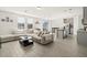 Open-concept living room with lots of natural light, adjacent to the kitchen at 3224 Fresno Pl, Zephyrhills, FL 33541