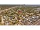 Wide aerial shot showcases the house’s location, marked by a red pin, nestled within a community near commercial zones and the bay at 3235 34Th N Ave, St Petersburg, FL 33713