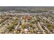 High-angle shot shows a house with a red pin, nestled in a neighborhood filled with tree-lined streets and charming homes at 3235 34Th N Ave, St Petersburg, FL 33713