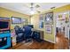 Bedroom featuring a desk setup, hardwood floors, fan, and eclectic decor at 3235 34Th N Ave, St Petersburg, FL 33713