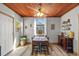 A dining area boasts a wood-paneled ceiling, a dining table, and a bar with spirits in close proximity at 3235 34Th N Ave, St Petersburg, FL 33713