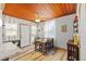 Bright dining area with a dining table, chairs, wood-paneled ceiling, wood floors, and lots of natural light at 3235 34Th N Ave, St Petersburg, FL 33713