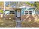 Charming home with brick facade, front yard with mature landscaping, and white front door at 3235 34Th N Ave, St Petersburg, FL 33713
