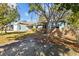 Charming single Gathering home featuring brick facade, tidy lawn, mature trees, and a detached garage on a sunny day at 3235 34Th N Ave, St Petersburg, FL 33713
