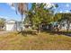 Charming single Gathering home with a tidy front lawn, mature trees, and a detached garage on a sunny day at 3235 34Th N Ave, St Petersburg, FL 33713
