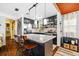 Modern kitchen with dark cabinets, a marble island, stainless steel appliances, and wood floors at 3235 34Th N Ave, St Petersburg, FL 33713