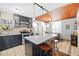 A beautifully designed kitchen boasts sleek black cabinets, stainless steel appliances, and a marble-top island with bar seating at 3235 34Th N Ave, St Petersburg, FL 33713