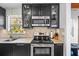 This kitchen features stainless steel appliances, a cooktop, a microwave, and stylish cabinets with glass door inserts at 3235 34Th N Ave, St Petersburg, FL 33713