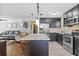 A spacious kitchen opens to a living room, with stainless steel appliances, and a marble-top island with bar seating at 3235 34Th N Ave, St Petersburg, FL 33713