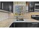 Modern kitchen features granite countertops, a stylish backsplash, stainless steel appliances, and a window with a view at 3235 34Th N Ave, St Petersburg, FL 33713