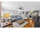 Inviting living room featuring hardwood floors, comfortable seating, and seamless flow to the kitchen at 3235 34Th N Ave, St Petersburg, FL 33713