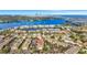 An aerial view of a waterfront condo community with a pool surrounded by lush landscaping in a quiet neighborhood at 3870 Island Way, St Petersburg, FL 33705