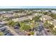 Scenic aerial view of yellow townhomes with a pool, parking, and serene waterfront backdrop at 3870 Island Way, St Petersburg, FL 33705