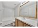 Bathroom with tub shower combo and light wood vanity with an oval sink at 3870 Island Way, St Petersburg, FL 33705