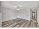 Large bedroom featuring wood-look floors, a ceiling fan, and double closet doors at 3870 Island Way, St Petersburg, FL 33705