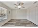 Bedroom with laminate flooring, a ceiling fan, double closet doors, and a window at 3870 Island Way, St Petersburg, FL 33705